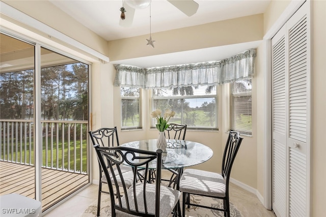 sunroom featuring ceiling fan and plenty of natural light