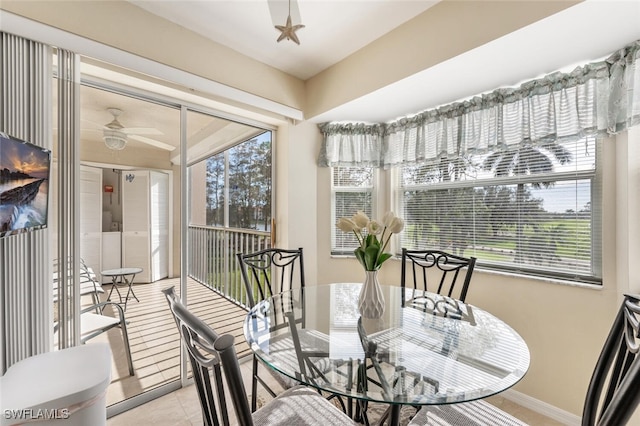 tiled dining room featuring ceiling fan