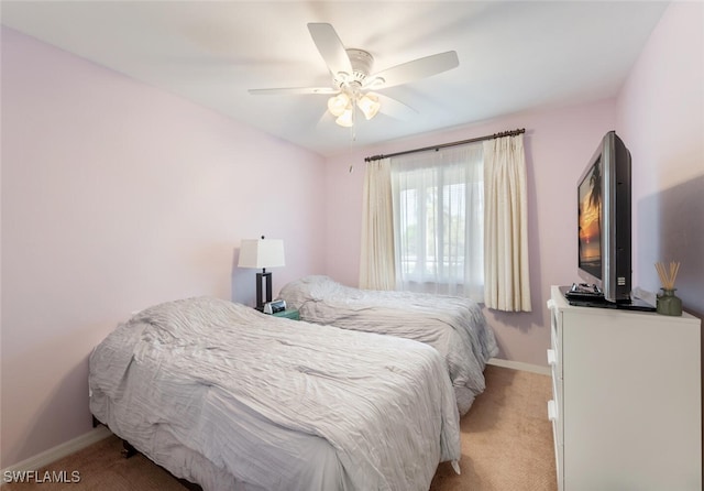 bedroom with light carpet and ceiling fan