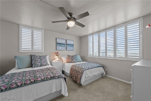 bedroom featuring ceiling fan and light carpet