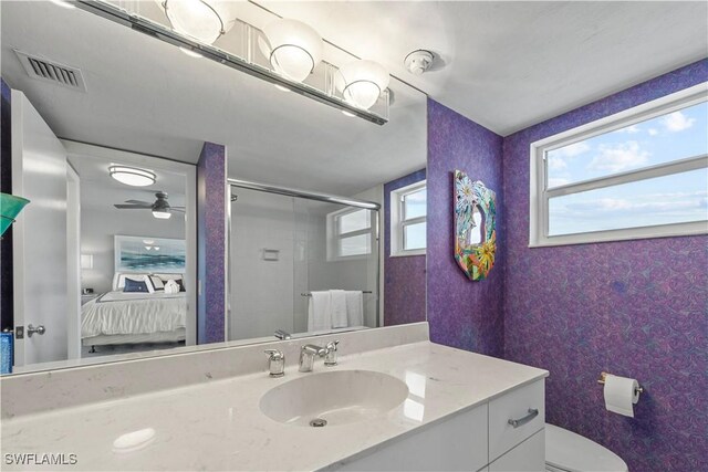 bathroom with vanity, toilet, and walk in shower