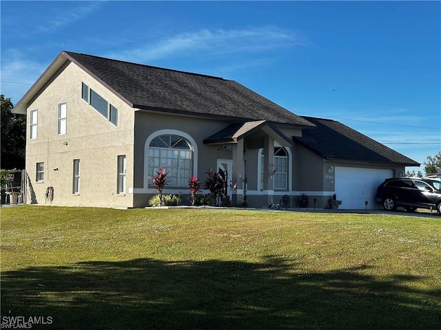 view of front of house with a garage and a front lawn