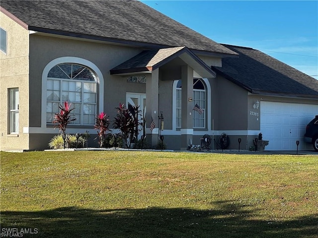 view of front of home with a garage and a front yard