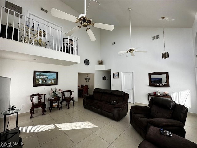 living room with high vaulted ceiling, ceiling fan, and light tile patterned flooring