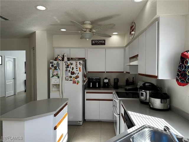 kitchen featuring a textured ceiling, white cabinetry, ceiling fan, and white appliances