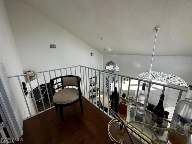 corridor featuring hardwood / wood-style flooring and high vaulted ceiling