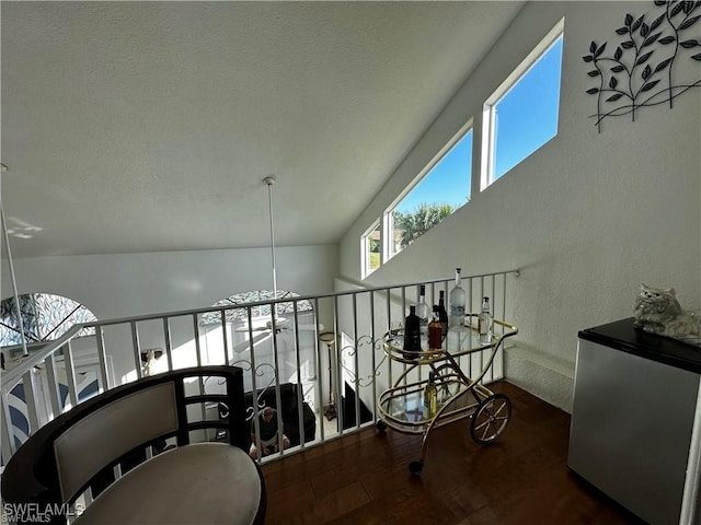 hall with vaulted ceiling and dark hardwood / wood-style floors