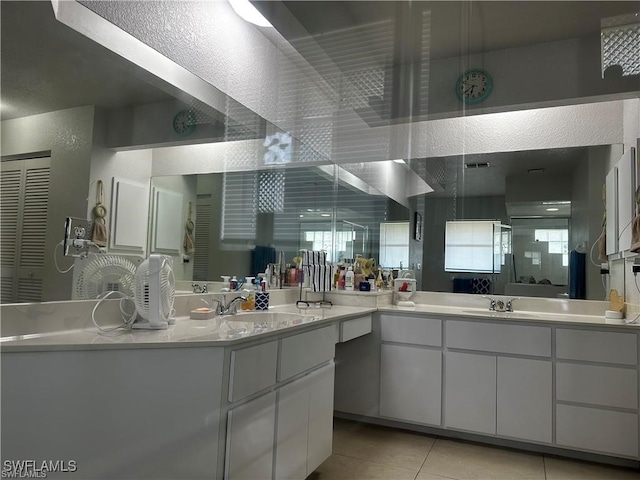 bathroom with tile patterned floors, vanity, and an enclosed shower