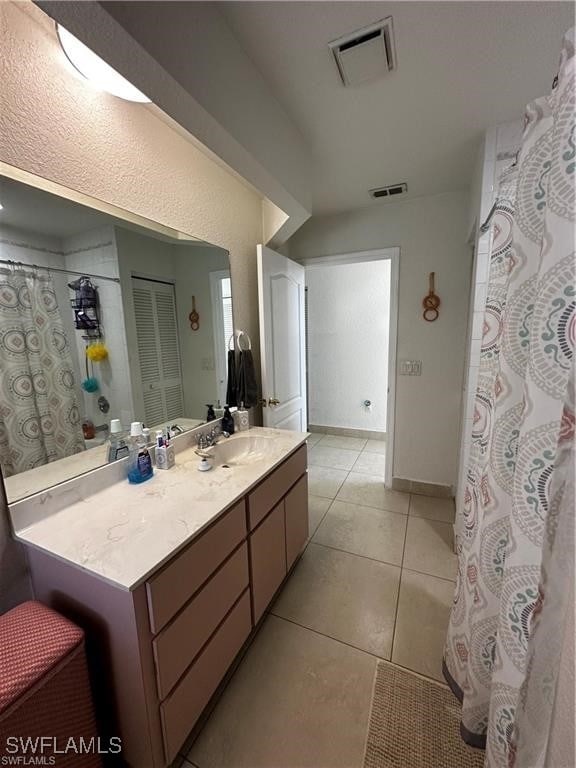 bathroom featuring tile patterned flooring and vanity