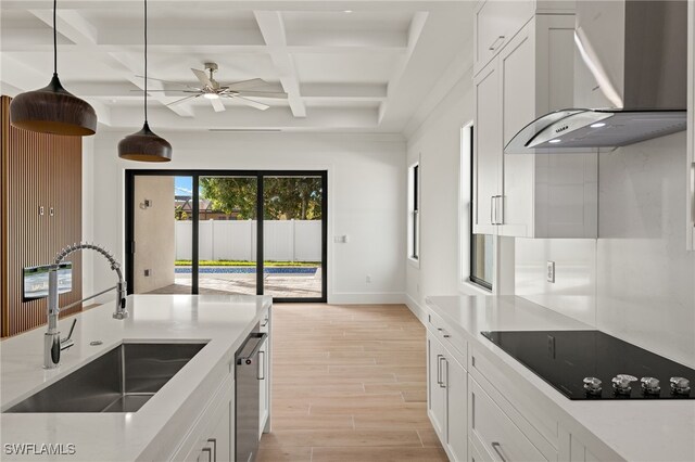 kitchen with white cabinetry, sink, wall chimney exhaust hood, coffered ceiling, and black electric cooktop