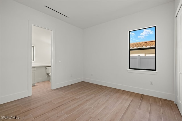 unfurnished room featuring light wood finished floors and baseboards