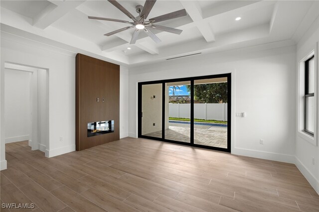 unfurnished room with light hardwood / wood-style floors, plenty of natural light, coffered ceiling, and ceiling fan