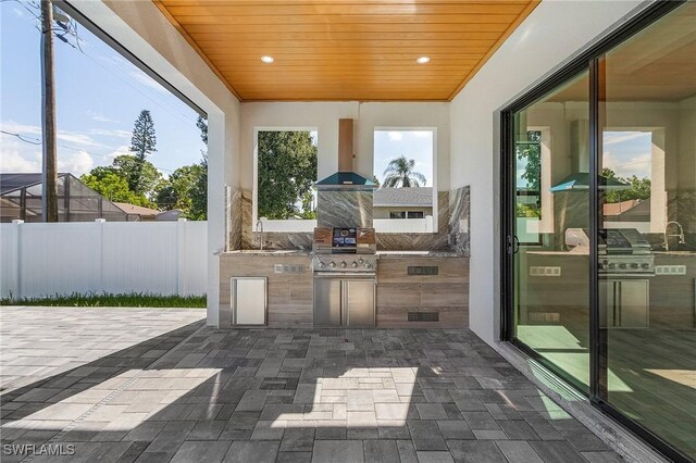 view of patio with area for grilling, exterior kitchen, and sink