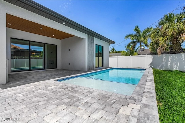 view of swimming pool with a patio area, fence, and a fenced in pool