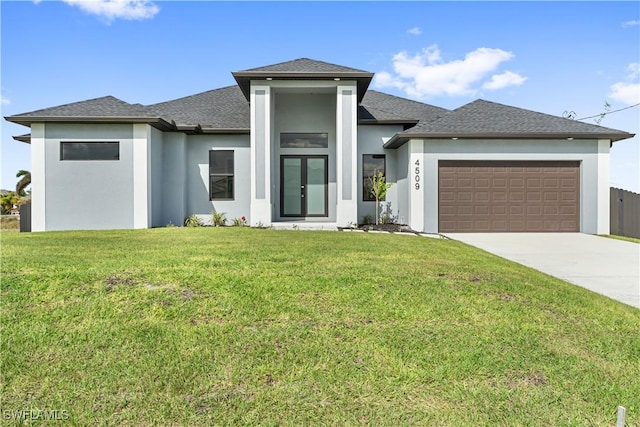 prairie-style home with french doors, a garage, and a front lawn