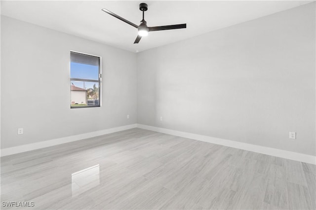 empty room with ceiling fan and light hardwood / wood-style floors