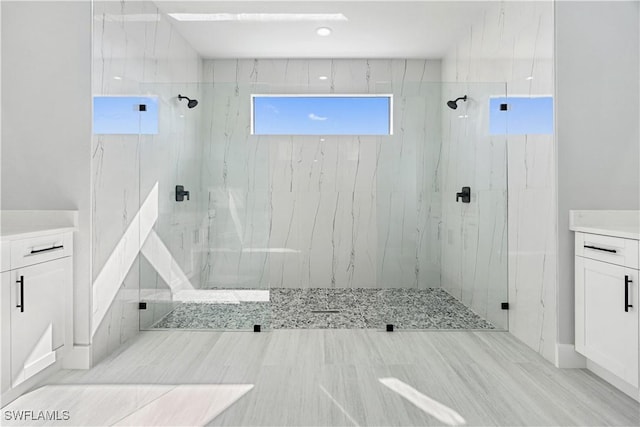 bathroom featuring vanity and tiled shower