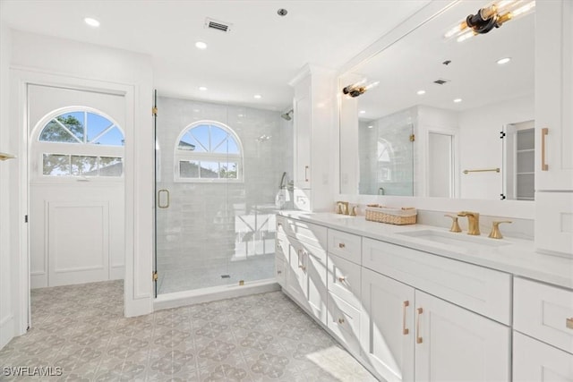bathroom with plenty of natural light, a stall shower, double vanity, recessed lighting, and tile patterned floors
