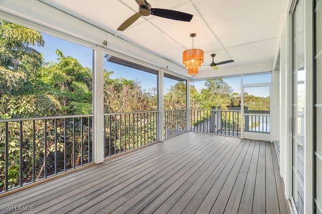 unfurnished sunroom featuring ceiling fan