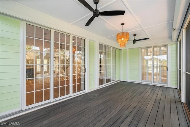 unfurnished sunroom featuring a ceiling fan and wood finished floors