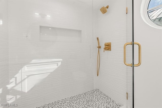 bathroom featuring a shower stall and toilet