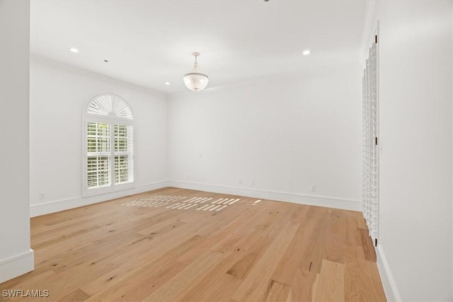 unfurnished room featuring light wood-type flooring, baseboards, recessed lighting, and ornamental molding