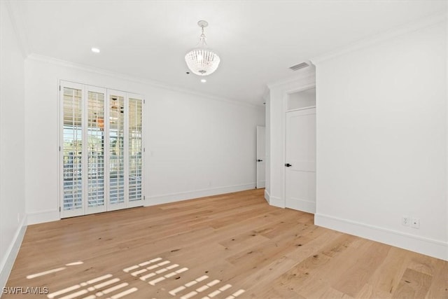 empty room featuring crown molding, baseboards, light wood finished floors, a chandelier, and recessed lighting