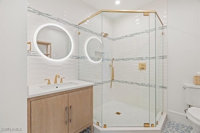 bathroom featuring an enclosed shower, vanity, and toilet