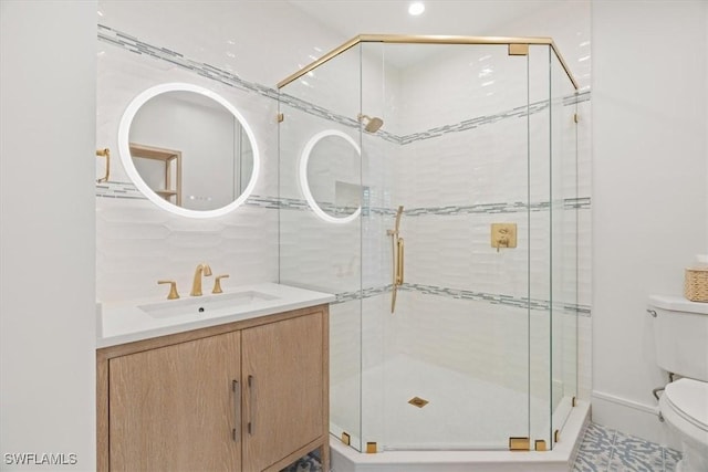 full bathroom featuring toilet, a stall shower, and vanity