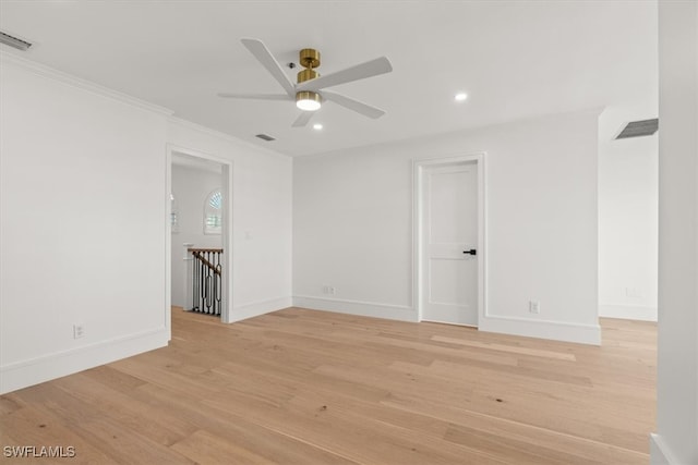 spare room with light wood-type flooring, ceiling fan, and crown molding