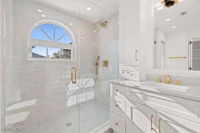 bathroom featuring vanity and an enclosed shower