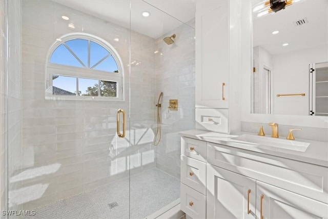full bathroom with a stall shower, vanity, and recessed lighting