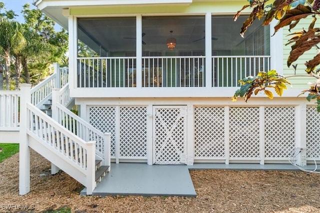 view of home's exterior featuring a sunroom and stairs