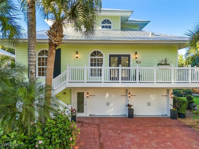 view of front of property featuring french doors and a garage