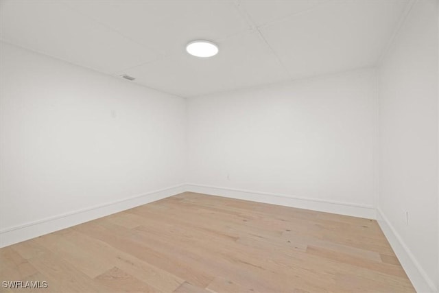 spare room featuring light wood finished floors and baseboards