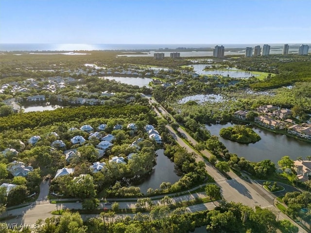 aerial view of property's location featuring a large body of water and nearby suburban area