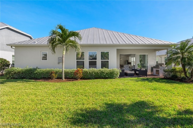 rear view of house featuring a yard and an outdoor hangout area