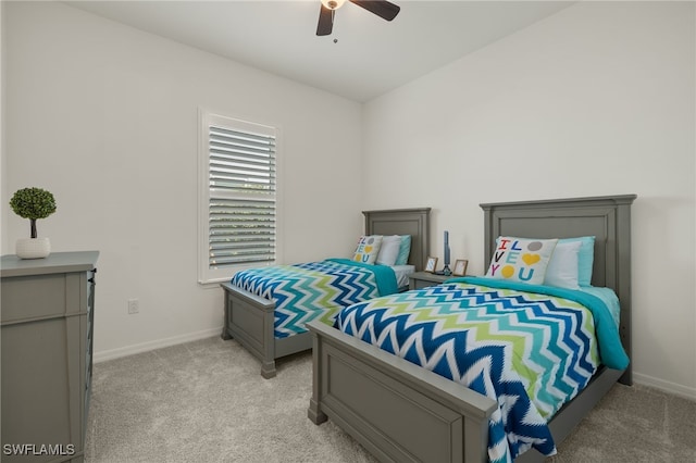 bedroom featuring ceiling fan and light carpet