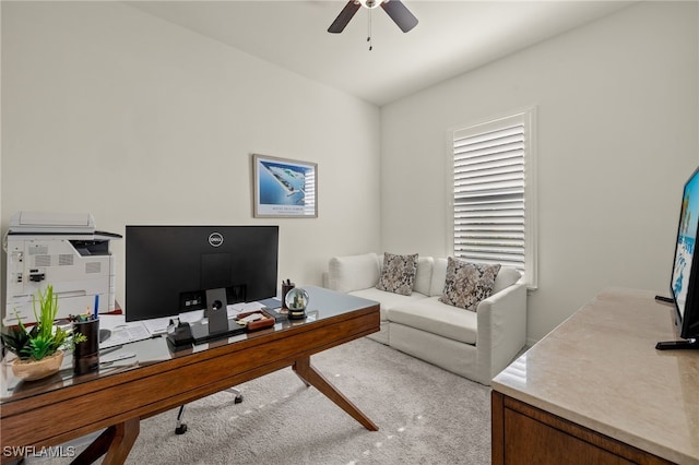 carpeted office space with ceiling fan