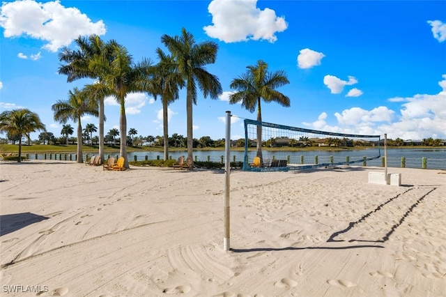 view of property's community featuring volleyball court and a water view