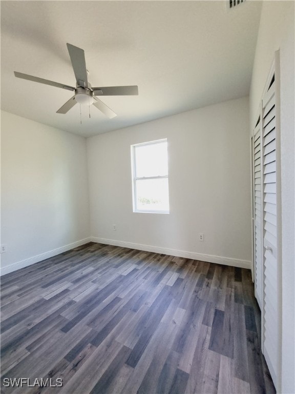 unfurnished bedroom featuring ceiling fan and dark wood-type flooring