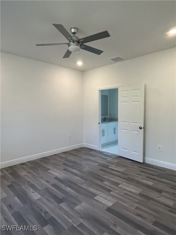 spare room featuring ceiling fan and dark hardwood / wood-style flooring