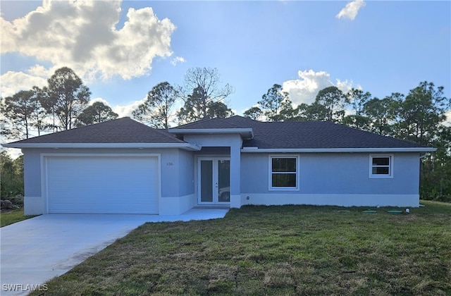 view of front of house featuring a front yard and a garage