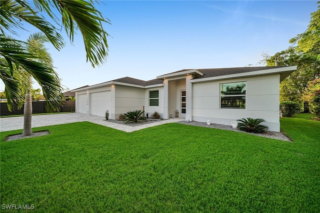 view of front facade with a garage and a front yard