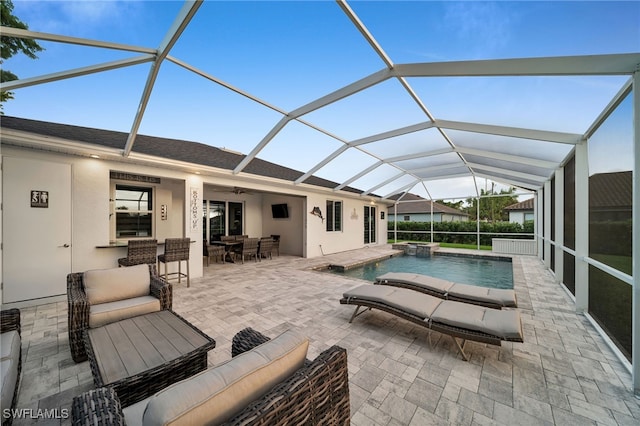 view of swimming pool featuring an outdoor living space, a patio, glass enclosure, and ceiling fan