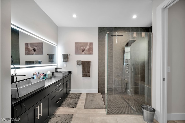 bathroom with a tile shower and vanity