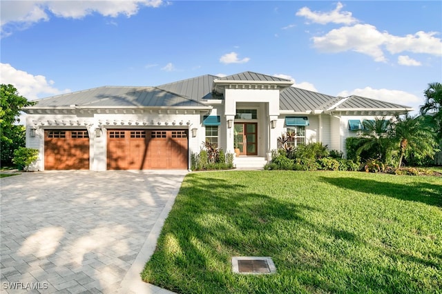 view of front of home featuring a front yard and a garage