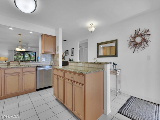 kitchen featuring dishwasher, sink, hanging light fixtures, kitchen peninsula, and light tile patterned floors