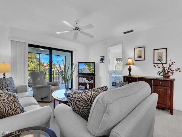 carpeted living room with ceiling fan