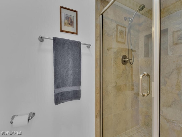 bathroom with a shower with door